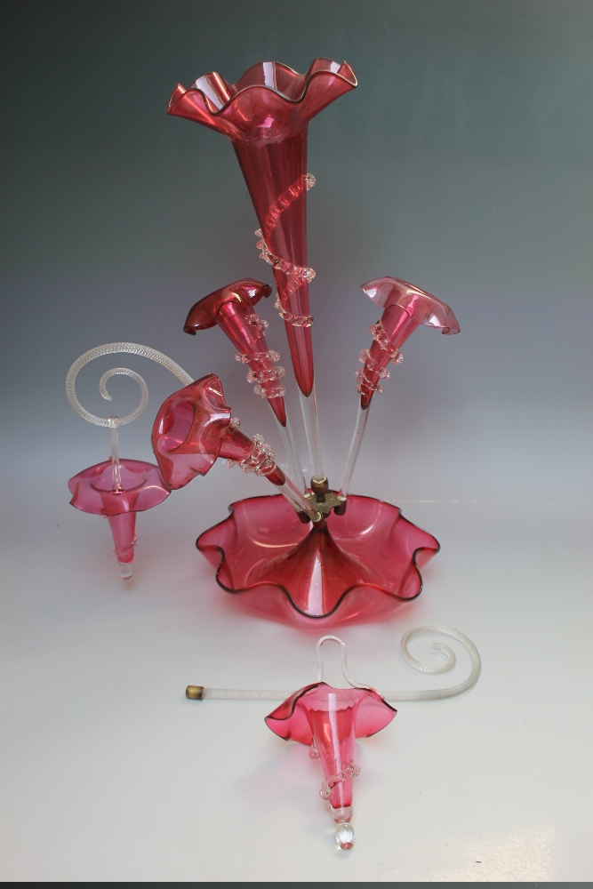 A VICTORIAN CRANBERRY GLASS EPERGNE, central frilled bowl and tall trumpet vase, with three further