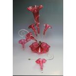 A VICTORIAN CRANBERRY GLASS EPERGNE, central frilled bowl and tall trumpet vase, with three further