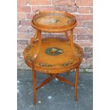 A PAINTED SATINWOOD CIRCULAR TWO TIER ETAGERE, the top tier with removable glass tray, floral paint