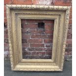 A 19TH CENTURY GILTWOOD DEEP MOULDING PICTURE FRAME, of rectangular outline, rebate 60 x 45 cm A/F