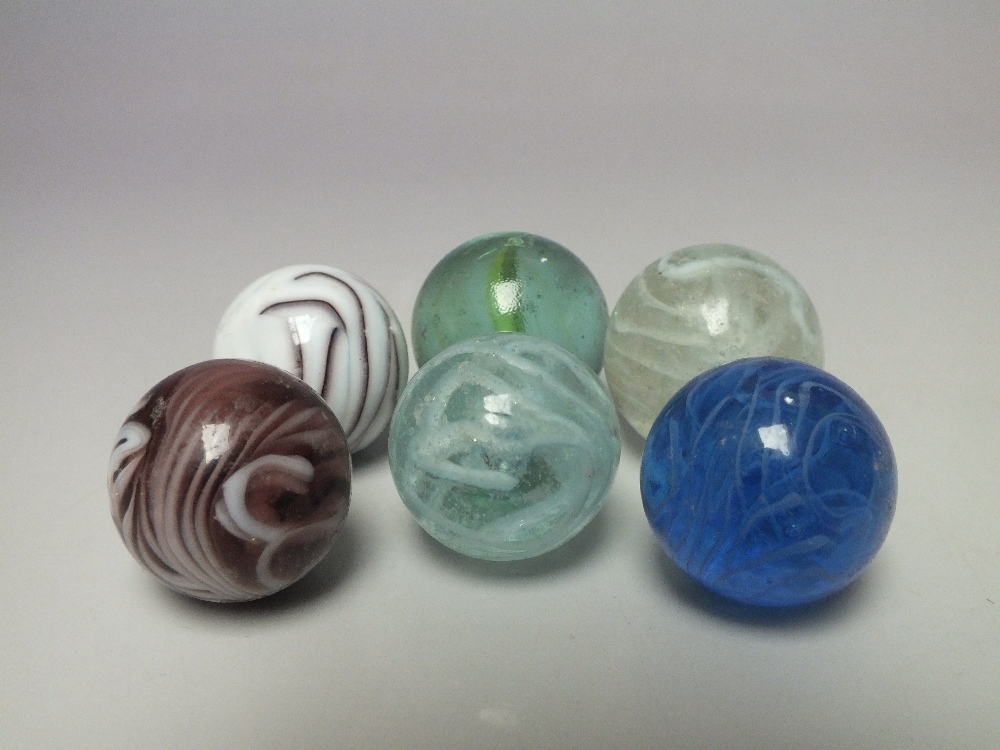 A COLLECTION OF SIX VINTAGE ART GLASS MARBLES, various colours and patterns to include ribbon effec