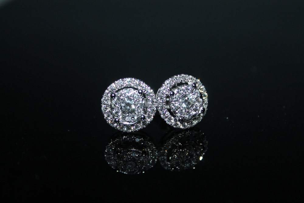 A PAIR OF HALLMARKED 18 CARAT WHITE GOLD DIAMOND CLUSTER EARRINGS, set with brilliant cut diamonds