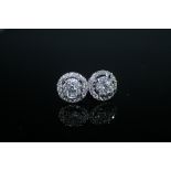 A PAIR OF HALLMARKED 18 CARAT WHITE GOLD DIAMOND CLUSTER EARRINGS, set with brilliant cut diamonds