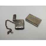 A HALLMARKED SILVER VESTA CASE ON CHAIN - BIRMINGHAM 1920, together with a white metal snuff box (2