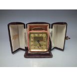 A VINTAGE 'BREVETE' LEATHER CASED TRAVEL ALARM CLOCK, retailer 'H Piddock & Sons Ltd. Goldsmiths Ha