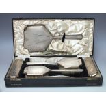 A CASED HALLMARKED SILVER SIX PIECE DRESSING TABLE SET - BIRMINGHAM 1933, makers mark for A & J Zim