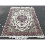 AN ORIENTAL WOOLLEN CARPET, having central floral cartouche, floral pattern throughout including bo