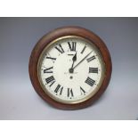 RAILWAY INTEREST - AN OAK CASED CIRCULAR WALL CLOCK, the 8" dial having Roman numerals, initialled