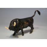 A 19TH CENTURY CAST BRONZE FIGURE OF A BULL, having painted definition to the eyes and mouth and pa