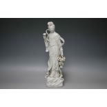 A CHINESE BLANC DE CHINE FIGURE OF GUAN YIN, holding a basket of Magnolia blossom, H 39.5 cm