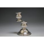 AN UNUSUAL SILVER HINGED DOUBLE CANDLESTICK, carrying import marks to base, H 14.5 cm