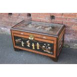 AN ORIENTAL SHIBAYAMA STYLE EBONISED STORAGE / BLANKET CHEST, having glazed panel to top, the decor