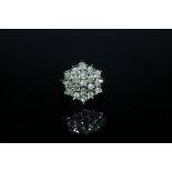 A 1 CARAT DIAMOND CLUSTER RING, having a cluster of brilliant cut diamonds illusion set in 9 carat
