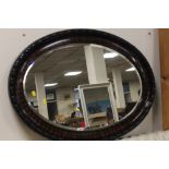 A MAHOGANY FRAMED OVAL MIRROR