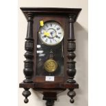 A MODERN MAHOGANY WALL CLOCK WITH PENDULUM