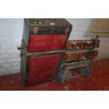 A METAL TOOL CABINET ON WHEELS TOGETHER WITH A WORK BENCH