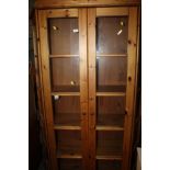 A LARGE PINE DISPLAY CABINET