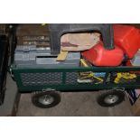 A PULL ALONG GARDEN TROLLEY TOGETHER WITH A QUANTITY OF JERRY CANS, ETC