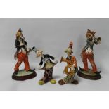 FOUR FIGURES OF CLOWNS PLAYING INSTRUMENTS