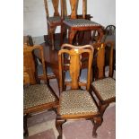 AN EXTENDING CIRCULAR MAHOGANY DINING ROOM TABLE WITH THREE LEAVES TOGETHER WITH A SET OF EIGHT