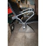 A RETRO ZOEFTIG COMMERCIAL STYLE CHAIR WITH ATTACHED GLASS TABLE