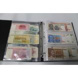 A FOLDER CONTAINING A COLLECTION OF WORLD BANK NOTES