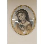 AN OVAL FRAMED AND GLAZED PORTRAIT OF A GIRL
