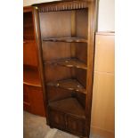 AN OAK LINEN FOLD CORNER CUPBOARD