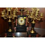 A BLACK MARBLE CLOCK GARNITURE WITH GILT METAL FITTINGS