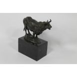 A SIGNED CAST BULL ON PLINTH