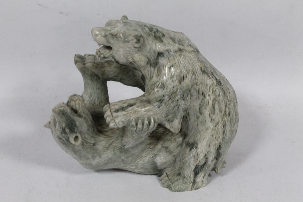 A CARVED CHINESE JADEITE FIGURE OF TWO FIGHTING BEARS