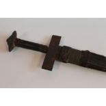 AN AFRICAN SWORD - POSSIBLY NIGERIAN, of cruciform style and a carved wood instrument (possibly Ind