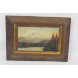 A FRAMED OIL ON BOARD OF A LAKESIDE MOUNTAINOUS SCENE, written to the reverse 'G C Bingham - In the