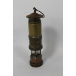 A SMALL HOME MADE MODEL OF A MINERS LAMP, with coin top and bottom. Height 13 cm