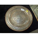 AN EASTERN SILVER PLATED ON COPPER CHARGER/PLATE WITH FIGURATIVE AND BIRD DECORATION