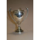 A SMALL HALLMARKED SILVER TWIN HANDLES TROPHY CUP