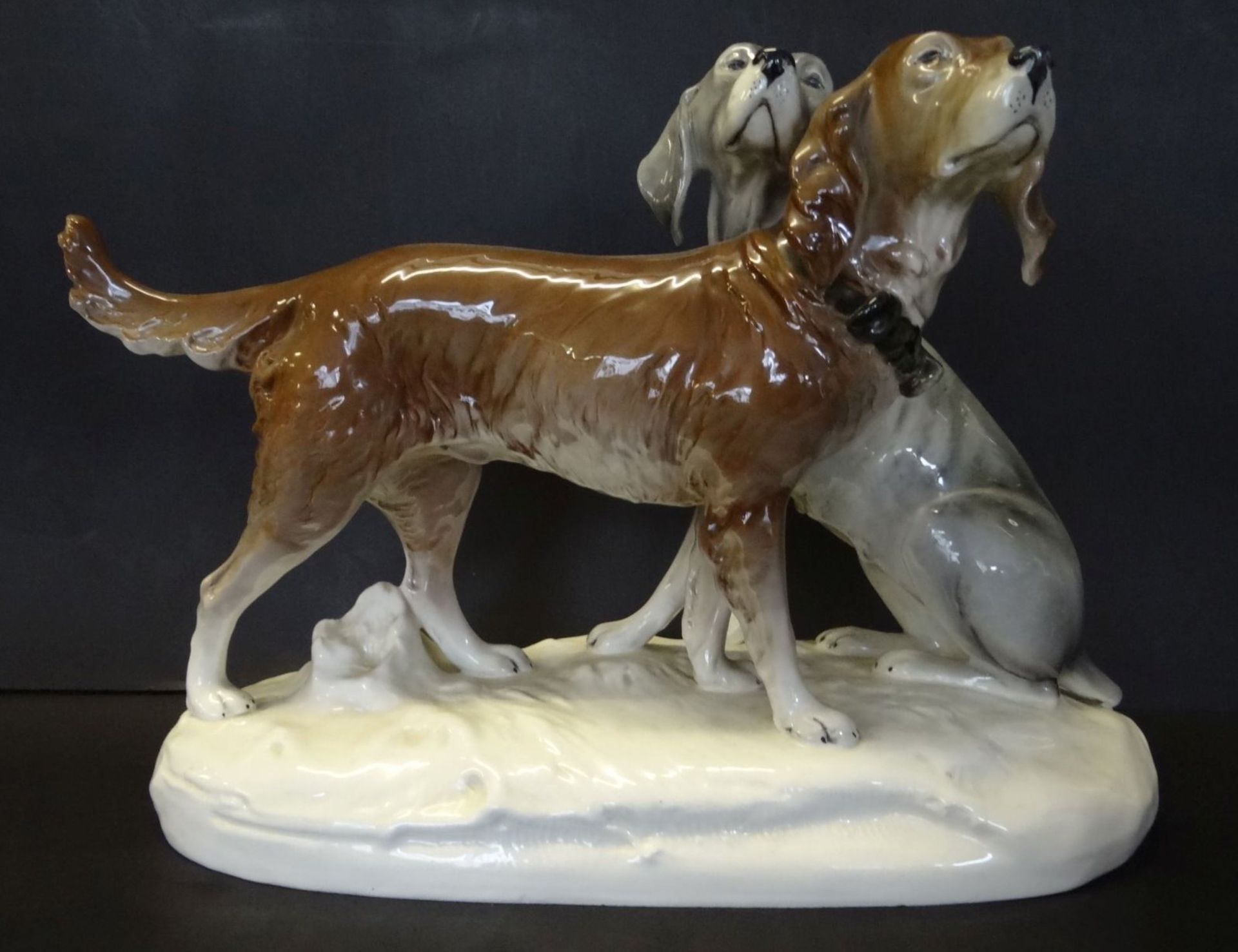 grosses Hundepaar "Royal Dux" bemalt, H-30 cm, L-43 cm, kl. Abplatzer am Sockel