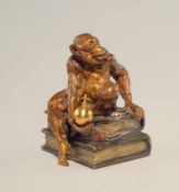 Wiener Bronze: Der Affe als König Ein Affe sitzt auf Gesetzesbüchern und hält Reichsapfel und Zepter
