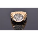 A yellow metal and diamond gents ring (tests as gold), pave set with ten round cut diamonds of