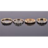 A collection of four gold and diamond rings comprising an 18 carat yellow gold and diamond ring (