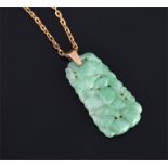 A Chinese green jade pendant of tapered rectangular form having pierced and carved fruit decoration,