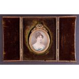 An early 19th century portrait miniature of a young lady wearing a blue gown, c. 1810, watercolour