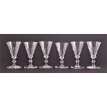 A harlequin set of six Georgian stemmed port glasses with tapered conical bowls, with annular