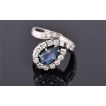 An unusual 14 carat white gold, diamond, and sapphire snake-style cluster ring set with a pear cut