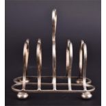 An Edwardian silver four-division toast rack having heart-shaped carrying handle and divisions, on