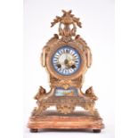 A late 19th century French ormolu and porcelain mantel clock the painted porcelain dial decorated