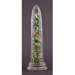 A 19th century 'end of day' glass obelisk decorated with colourful glass scrambles, supported on a