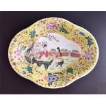 A late 19th century Chinese porcelain famille jaune shaped dish the centre decorated with a scene of