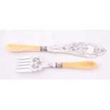 A pair of Victorian Ivory handled silver plated fish servers the knife blade engraved with a scene