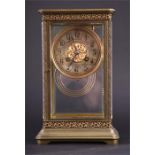 A late 19th century French four glass mantel clock the white enamel dial with black Roman